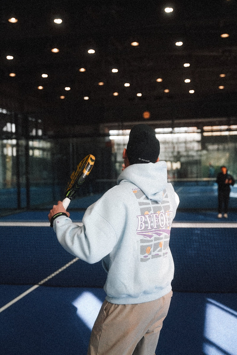 Padel player in blue byfour Padel clothing about to hit a smash